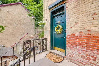 a blue door on the side of a brick building at Charming Getaway Less Than 1 Mi to Downtown Lambertville! in Lambertville