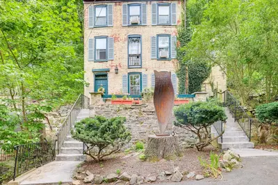 a house with a statue in front of it at Charming Getaway Less Than 1 Mi to Downtown Lambertville! in Lambertville