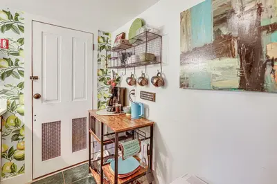 a small kitchen with a table and a door at Charming Getaway Less Than 1 Mi to Downtown Lambertville! in Lambertville
