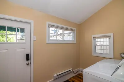 a bathroom with a toilet and two windows at 915CountyLineRoad Luxury Mainline Train Colleges in Bryn Mawr