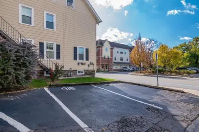 an empty parking lot in front of a house at 915CountyLineRoad Luxury Mainline Train Colleges in Bryn Mawr