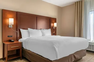 a bed in a hotel room with a large white bed at Comfort Suites Camp Hill-Harrisburg West in Harrisburg