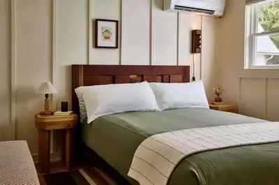 a bedroom with a green bed and a window at Callicoon Hills in Callicoon Center