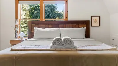 a bedroom with a bed with two towels on it at Callicoon Hills in Callicoon Center