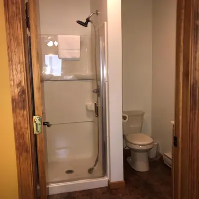 a bathroom with a shower and a toilet at Trout Town Inn in Roscoe