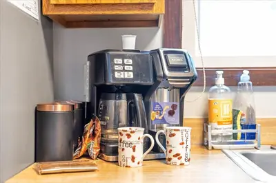 a coffee maker sitting on top of a counter with mugs at 180 SKI CAMELBACK-SKI-ON -SKI OFF,SNOW TUBING,Paintball in Tannersville