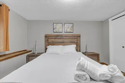 a bedroom with a white bed with towels on it at 180 SKI CAMELBACK-SKI-ON -SKI OFF,SNOW TUBING,Paintball in Tannersville