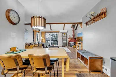 a dining room and living room with a table and chairs at 180 SKI CAMELBACK-SKI-ON -SKI OFF,SNOW TUBING,Paintball in Tannersville