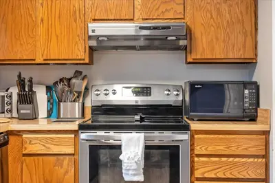 a kitchen with a stove and a microwave at 180 SKI CAMELBACK-SKI-ON -SKI OFF,SNOW TUBING,Paintball in Tannersville