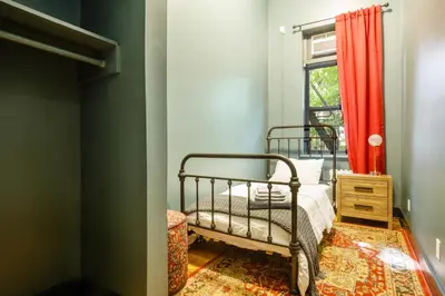 a bedroom with a bed and a window at Lamartine Chelsea in New York