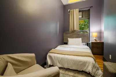 a bedroom with two beds and a window at Lamartine Chelsea in New York