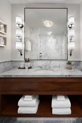 a bathroom with a large mirror and a tub at The Wall Street Hotel New York City in New York