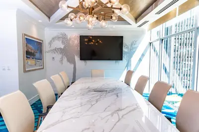 a dining room with a large marble table and chairs at Margaritaville Resort Times Square in New York