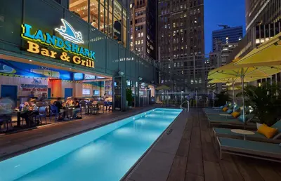 a pool in the middle of a city at night at Margaritaville Resort Times Square in New York