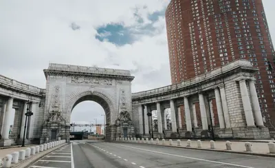 a building with an arch in the middle of a street at Leon Hotel LES in New York