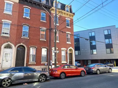 a group of cars parked in front of a brick building at AF Stays - Philadelphia 1224 Mt Vernon St in Philadelphia
