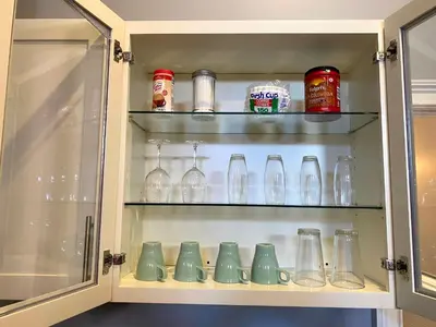 a cabinet filled with lots of glass vases at AF Stays - Philadelphia 1224 Mt Vernon St in Philadelphia