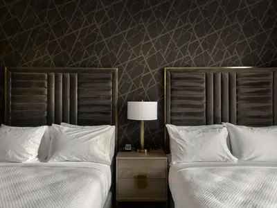 two beds sitting next to each other in a bedroom at The Chateau Grande Hotel in East Brunswick