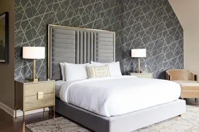 a bedroom with a large bed and two lamps at The Chateau Grande Hotel in East Brunswick