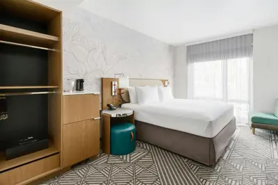 a hotel room with a bed and a flat screen tv at SpringHill Suites by Marriott New York Manhattan Chelsea in New York