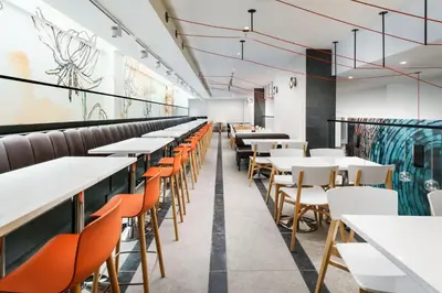 a row of tables and chairs in a restaurant at SpringHill Suites by Marriott New York Manhattan Chelsea in New York