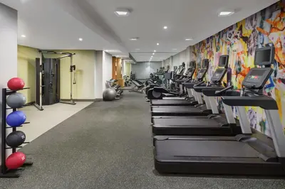 a gym with rows of treadmills and machines at SpringHill Suites by Marriott New York Manhattan Chelsea in New York