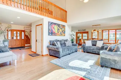 a living room with two couches and a rug at 4 Mi to Slopes! Split Rock Resort Home with Fire Pit in Lake Harmony