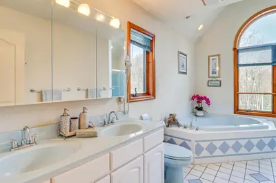 a bathroom with two sinks and a tub at 4 Mi to Slopes! Split Rock Resort Home with Fire Pit in Lake Harmony