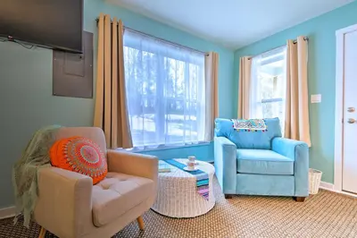 a living room with two chairs and a couch and a window at Unwind Fireside! Poconos Cottage 12 Mi to Slopes in Brodheadsville