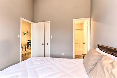 a bedroom with a white bed and two doors at Inviting Poconos Getaway with Deck Ski and Hike! in Mount Pocono