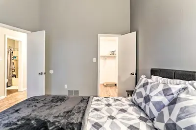 a bedroom with a bed with a gray wall at Inviting Poconos Getaway with Deck Ski and Hike! in Mount Pocono