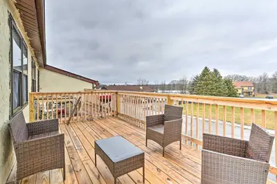a porch with chairs and a table on a deck at Inviting Poconos Getaway with Deck Ski and Hike! in Mount Pocono