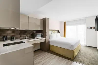 a hotel room with a bed and a kitchen at TownePlace Suites by Marriott New York Manhattan/Chelsea in New York