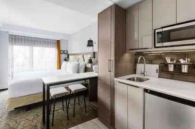 a hotel room with a bed and a kitchen at TownePlace Suites by Marriott New York Manhattan/Chelsea in New York