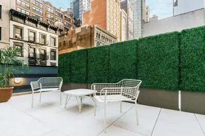 two chairs and a table on a balcony at TownePlace Suites by Marriott New York Manhattan/Chelsea in New York