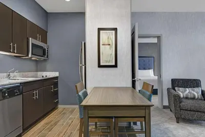 a kitchen with a table and a dining room at Homewood Suites By Hilton Edison Woodbridge, NJ in Edison