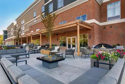 a patio with couches and tables and a building at Homewood Suites By Hilton Edison Woodbridge, NJ in Edison