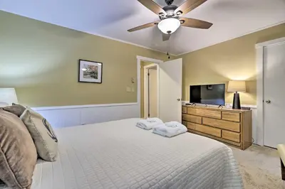 a bedroom with a bed and a ceiling fan at Cozy Poconos Townhome with Fireplace Near Jack Frost in Lake Harmony