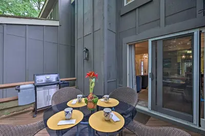 a table and chairs on a patio at Cozy Poconos Townhome with Fireplace Near Jack Frost in Lake Harmony
