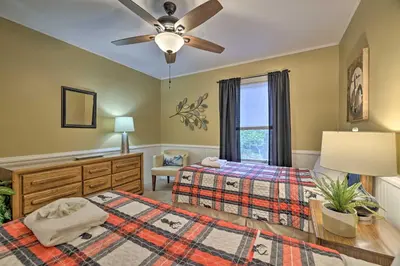 a bedroom with two beds and a ceiling fan at Cozy Poconos Townhome with Fireplace Near Jack Frost in Lake Harmony