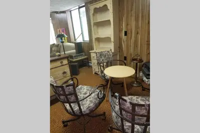 a room with chairs and a table and a desk at Regent Hilltop Cabin in Sandyville
