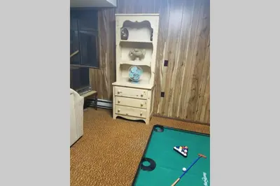 a room with a pool table and a cabinet at Regent Hilltop Cabin in Sandyville