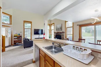 a kitchen with a sink and a living room at Northridge 181 in Tannersville