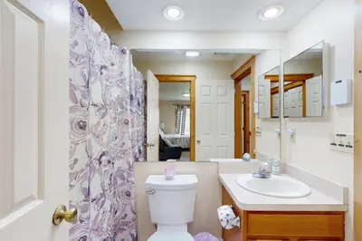a bathroom with a toilet and a sink and a mirror at Northridge 181 in Tannersville