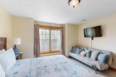 a bedroom with a bed and a couch at Northridge 181 in Tannersville