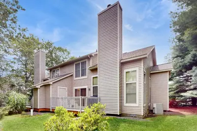 a large house with a balcony on a yard at Northridge 181 in Tannersville
