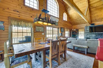 a dining room with a large wooden table in a cabin at Quiet Snow Estate Retreat in the Poconos in Nay Aug