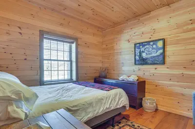 a bedroom with a bed in a log cabin at Quiet Snow Estate Retreat in the Poconos in Nay Aug