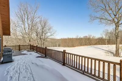 a snow covered porch of a house with a fence at Quiet Snow Estate Retreat in the Poconos in Nay Aug