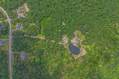 an aerial view of a road in a forest at Quiet Snow Estate Retreat in the Poconos in Nay Aug